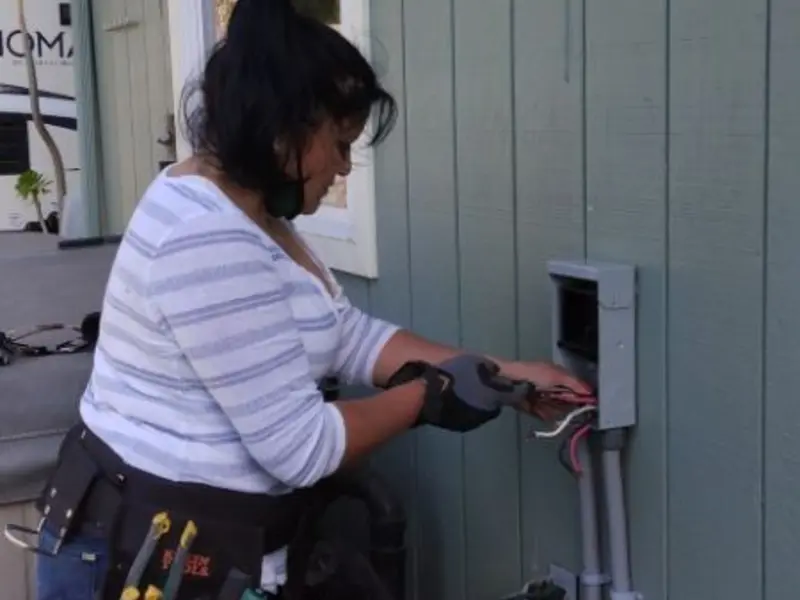 Licensed electrician wiring an exterior subpanel in Fort McKinley